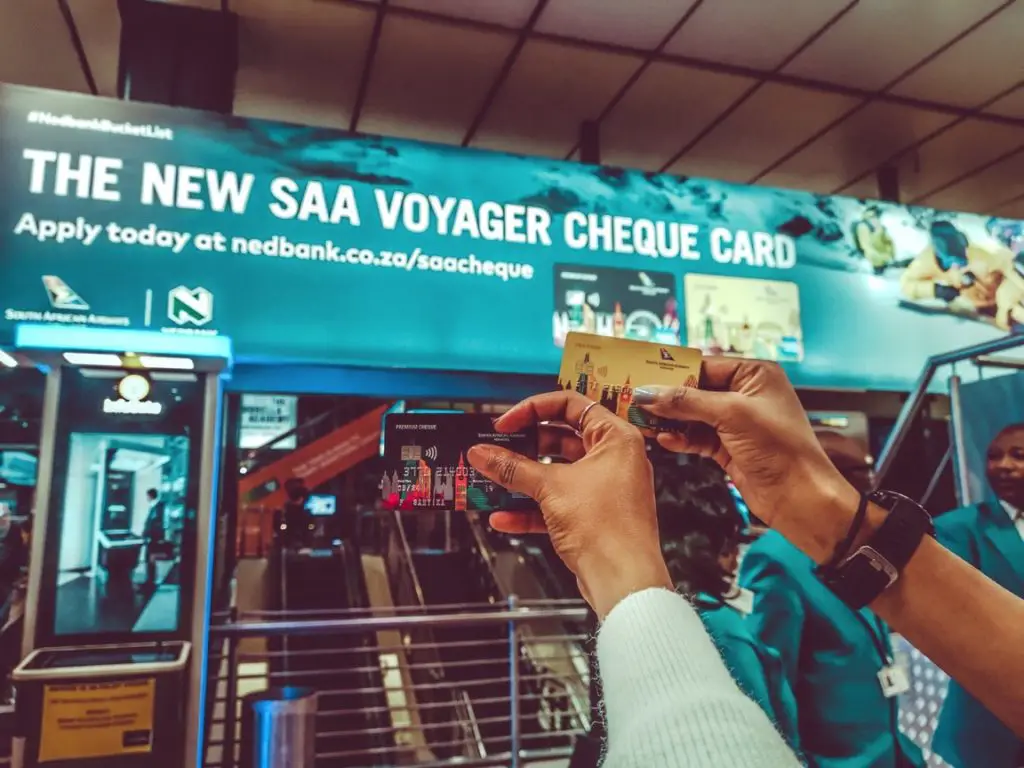 Farirai and Nyari holding the SAA Voyager cheque cards