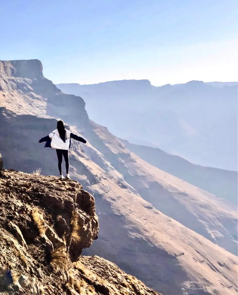 Gophari standing amongst the Drakensberg mountains