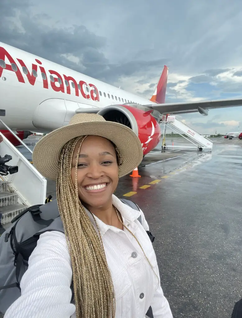 Gophari smiling in front of a plane